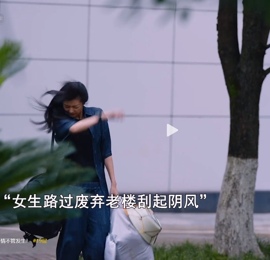 Cold eerie wind blows as a girl walks past the deserted old building.